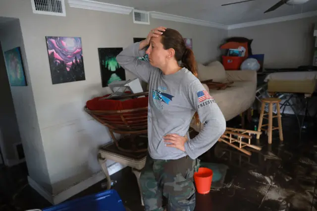 Stefanie Karas stands in her apartment after flood water inundated it when Hurricane Ian passed through the area on 29 September 2022 in Fort Myers, Florida. Mrs. Karas is an artist and was salvaging what she could from her home.