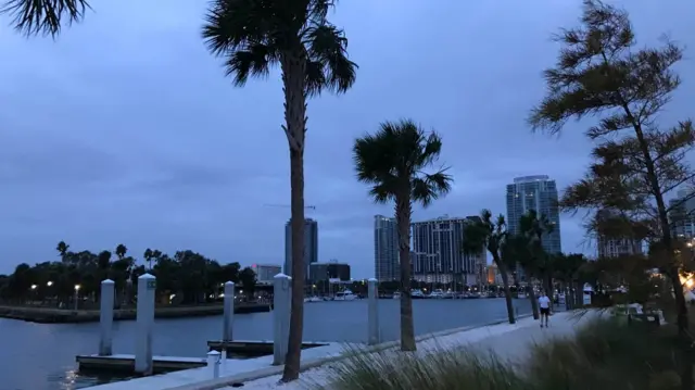 Man walking along waterside path in St Petersburg, Florida