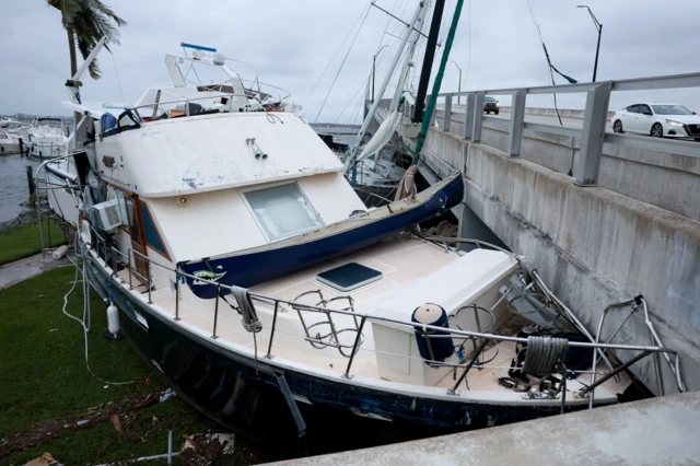 Boats are pushed up on a causeway after Hurricane Ian passed through the area on 29 September 2022