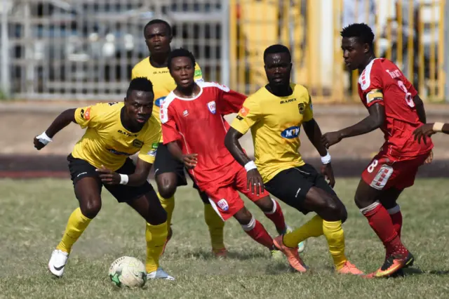 A picture taken on July 12, 2017 shows Kumasi Asante Kotoko Football Club's players vying for the ball with players of Inter Allies Football Club during a local league match at the El Wak stadium in Accra.