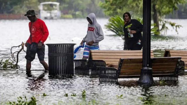 Orlando residents wade through flood water