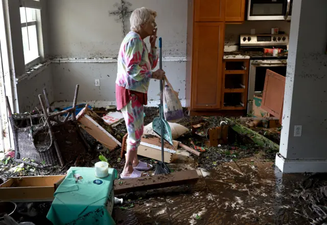 Stedi Scuderi looks over her apartment after flood water inundated it when Hurricane Ian passed through the area on 29 September 2022 in Fort Myers, Florida