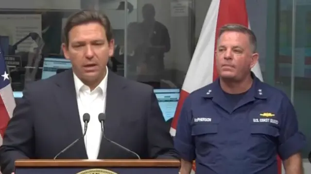 Governor Ron DeSantis (left) at briefing