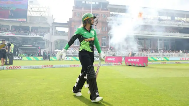 Danni Wyatt walks out to bat