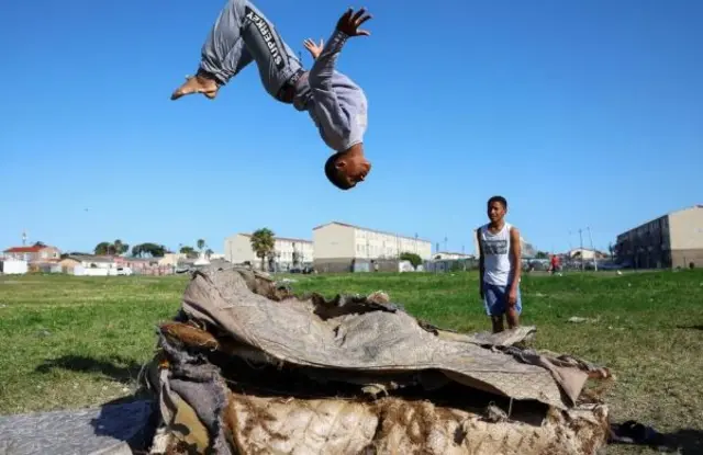 Boy doing black flip on mattress