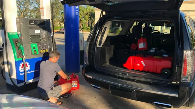 Dean Perfetti filling up jerry cans