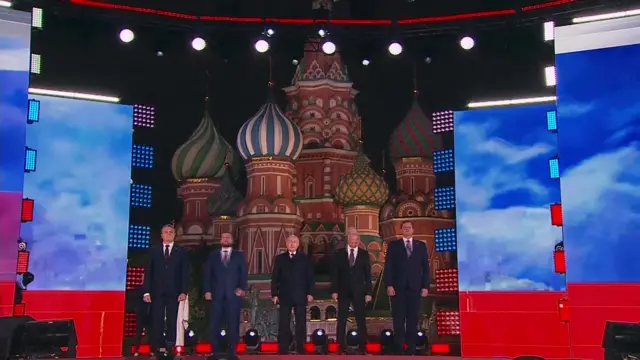 Vladimir Putin (centre) on stage at Red Square concert event on 30 September 2022