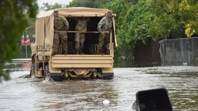 Members of the Florida National Guard look for stranded residents in a flooded neighborhood in the aftermath of Hurricane Ian on September 29, 2022 in Orlando, Florida.