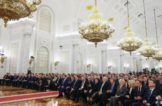 Participants listen to Russian President Vladimir Putin