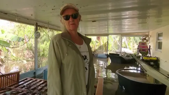 A woman in her destroyed home