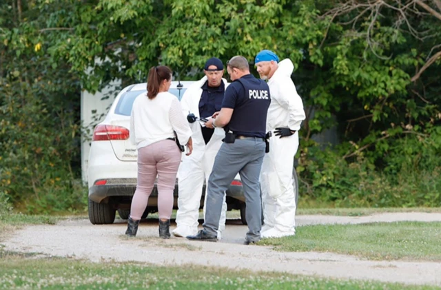 A police forensics team investigates a crime scene after multiple people were killed and injured in a stabbing spree in Weldon, Saskatchewan