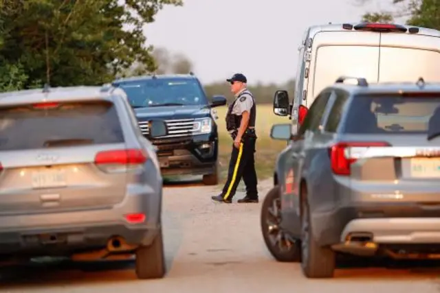 A Royal Canadian Mounted Police (RCMP) officer arrives at a crime scene after multiple people were killed and injured in a stabbing spree in Weldon, Saskatchewan