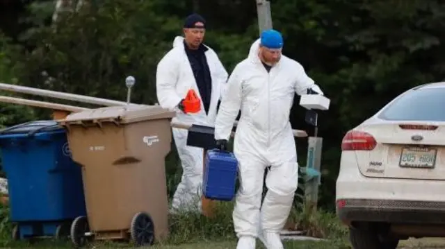 Forensic officers seen at an address