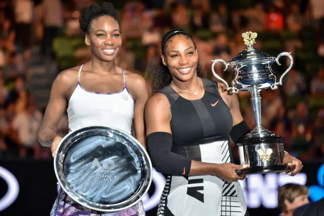 Venus Williams and Serena Williams with their trophies at the 2017 Australian Open