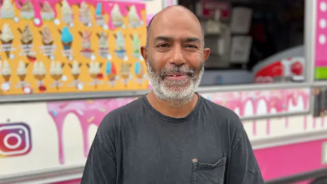 Anwar Noor stands in front of his ice cream van