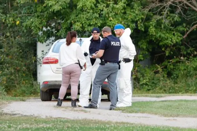 A police forensics team investigates a crime scene after multiple people were killed and injured in a stabbing spree in Weldon, Saskatchewan