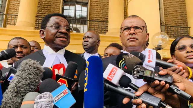 People speaking outside court