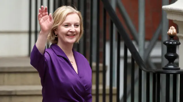 Liz Truss waves outside the Conservative Party headquarters