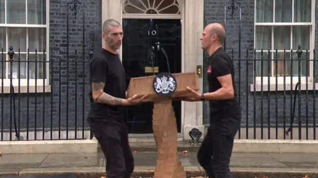 The lectern is removed from outside the front of No 10 by staff