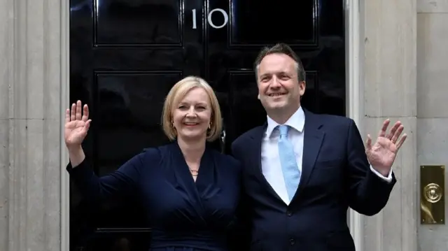 New British Prime Minister Liz Truss waves alongside her husband Hugh O'Leary outside Downing Street, in London, Britain September 6, 2022.