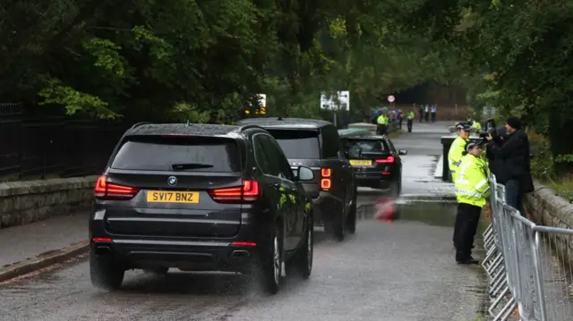 Three cars driving away from Balmoral castle