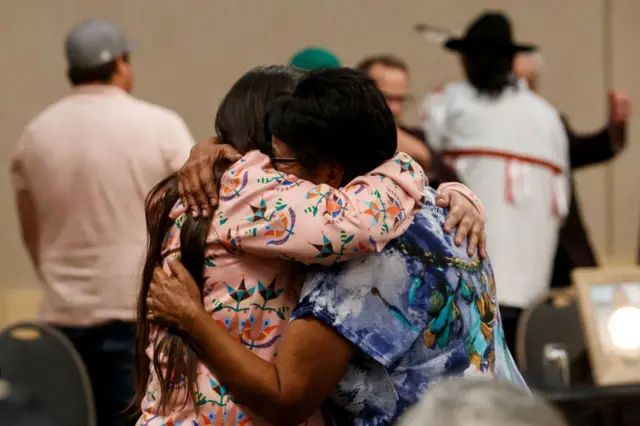 Family members of the victims of a series of stabbings on the James Smith Cree Nation reserve in the Canadian province of Saskatchewan hug during a news conference in Saskatoon, Saskatchewan, Canada, on September 7, 2022.