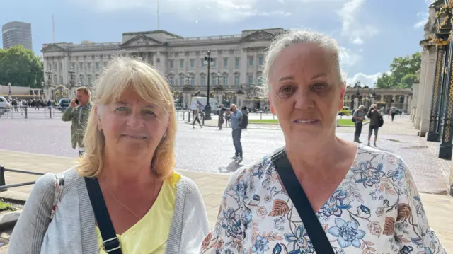 Pam Fleming and Kim Tierney standing outside Buckingham Palace