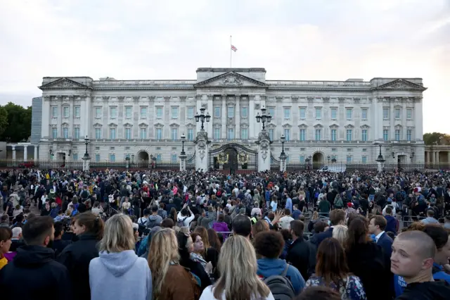 People gather outside the Buckingham Palace, after Queen Elizabeth, Britain's longest-reigning monarch and the nation's figurehead for seven decades, died aged 96,