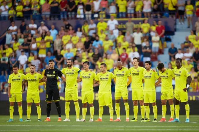 Villareal's team stand together before a match