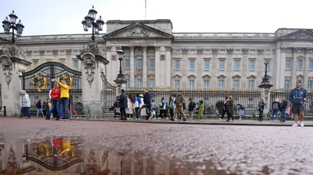 People gather outside Buckingham Palace, following statement from Buckingham Palace over concerns for the Queen's health