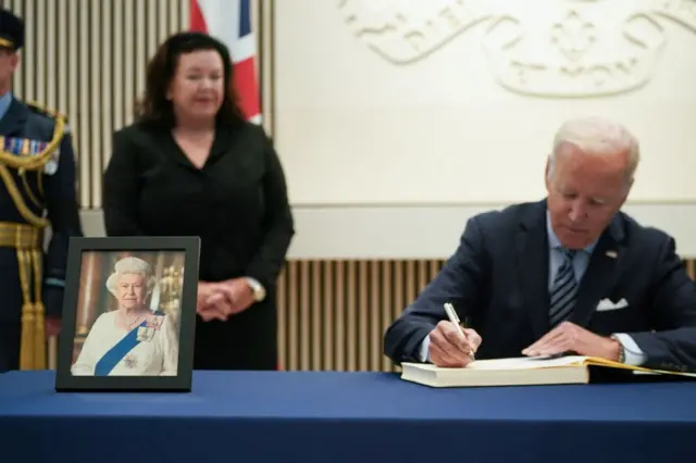 US President Joe Biden signs the condolence book at the British Embassy in Washington