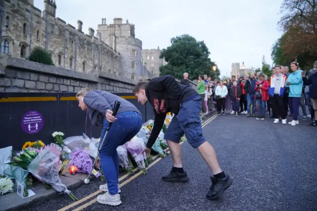 Mourners gather laying flowers outside Windsor Castle in Berkshire