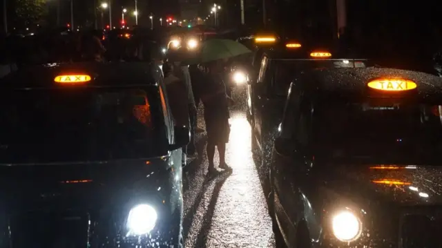 Taxis lined up on The Mall in central London, following the announcement of the death of Queen Elizabeth II.