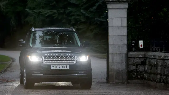 A vehicle carrying Britain's Prince Harry leaving Balmoral Castle