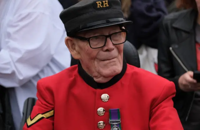 Michael Hull wears a red military blazer in honour of the Royal Family