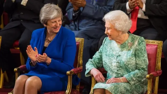 Former Prime Minister Theresa May talks with Queen Elizabeth II