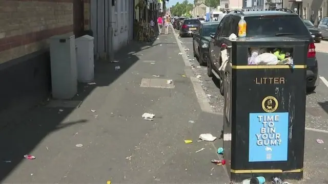 A street with overflowing bins