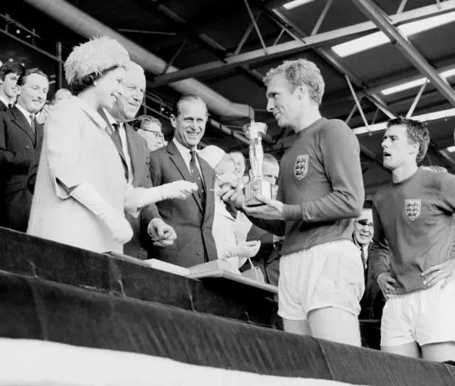 The Queen presents Bobby Moore with the Jules Rimet Trophy after England's World Cup win in 1966