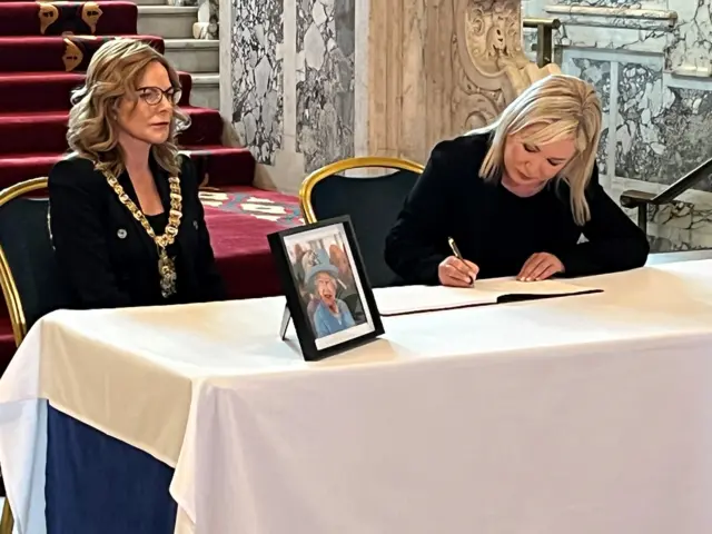 Michelle O'Neill signs the book of condolences at Belfast City Hall