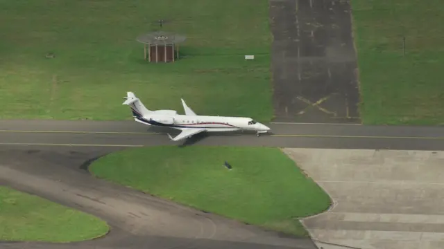 Plane carrying King Charles on runway