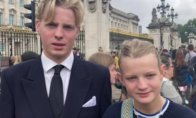 Charlie and Isabella Pemberton visit Buckingham Palace in their school uniforms