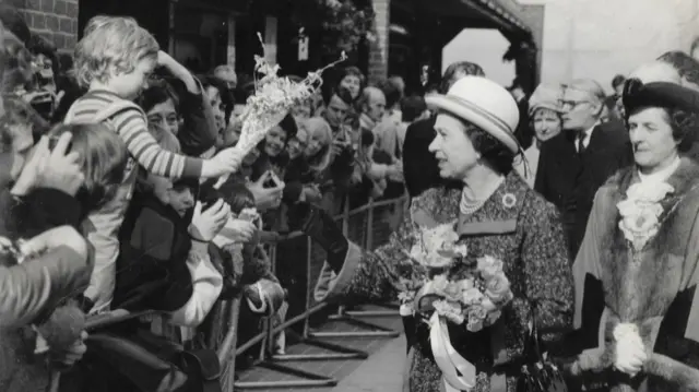 Nick Weymouth presenting the Queen with flowers in 1980