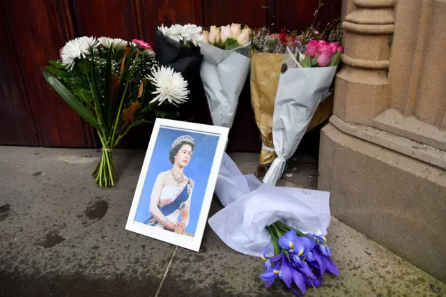 Bunches of flowers and a photograph of Queen Elizabeth II are left at the entrance of St. Andrew's Cathedral in Sydney, Australia,