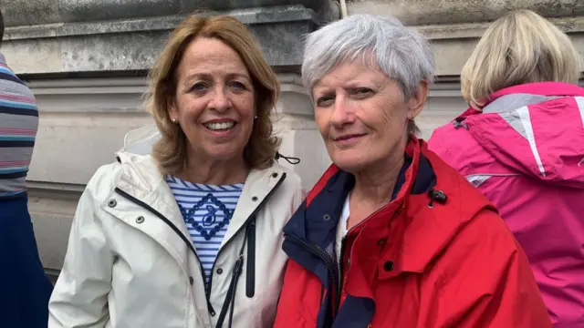 Jo Brinkworth and Sue Peat queuing to sign a book of condolence at Cardiff City Hall