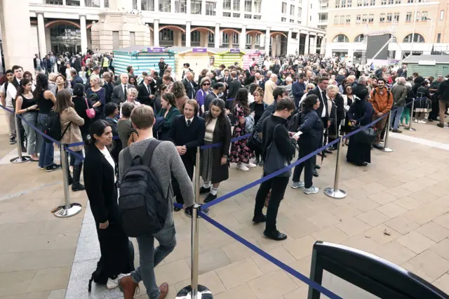Members of the public queue in Paternoster Square, London, ahead of the Service of Prayer and Reflection at St Paul's Cathedral following the death of Queen Elizabeth II