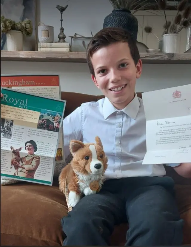Thomas with his "pet" corgi and letter from the Queen