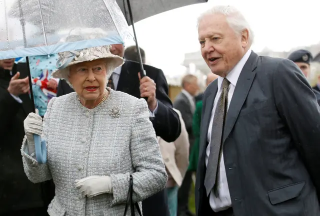 Queen Elizabeth walks with broadcaster David Attenborough during her visit to the \"Wild London\" exhibition in Richmond in May 2012