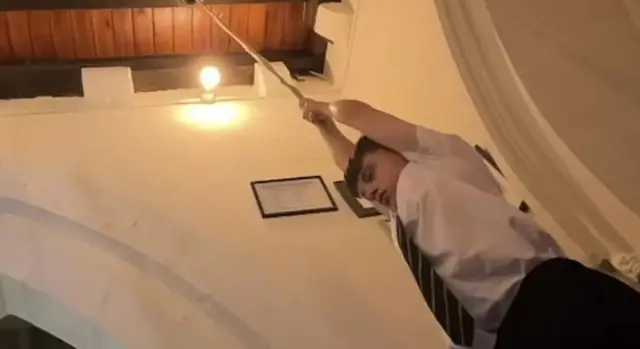Jayden pulls on a bell as he honours the Queen