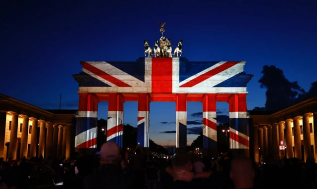 The Brandenburg Gate in Berlin is illuminated in the colours of the British union flag