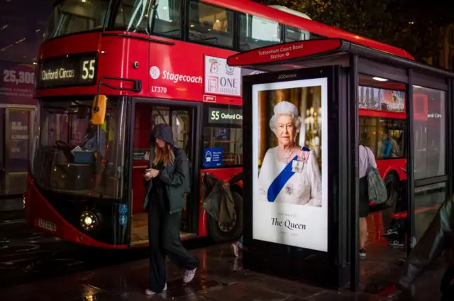 Bus stop in London with a picture of the Queen